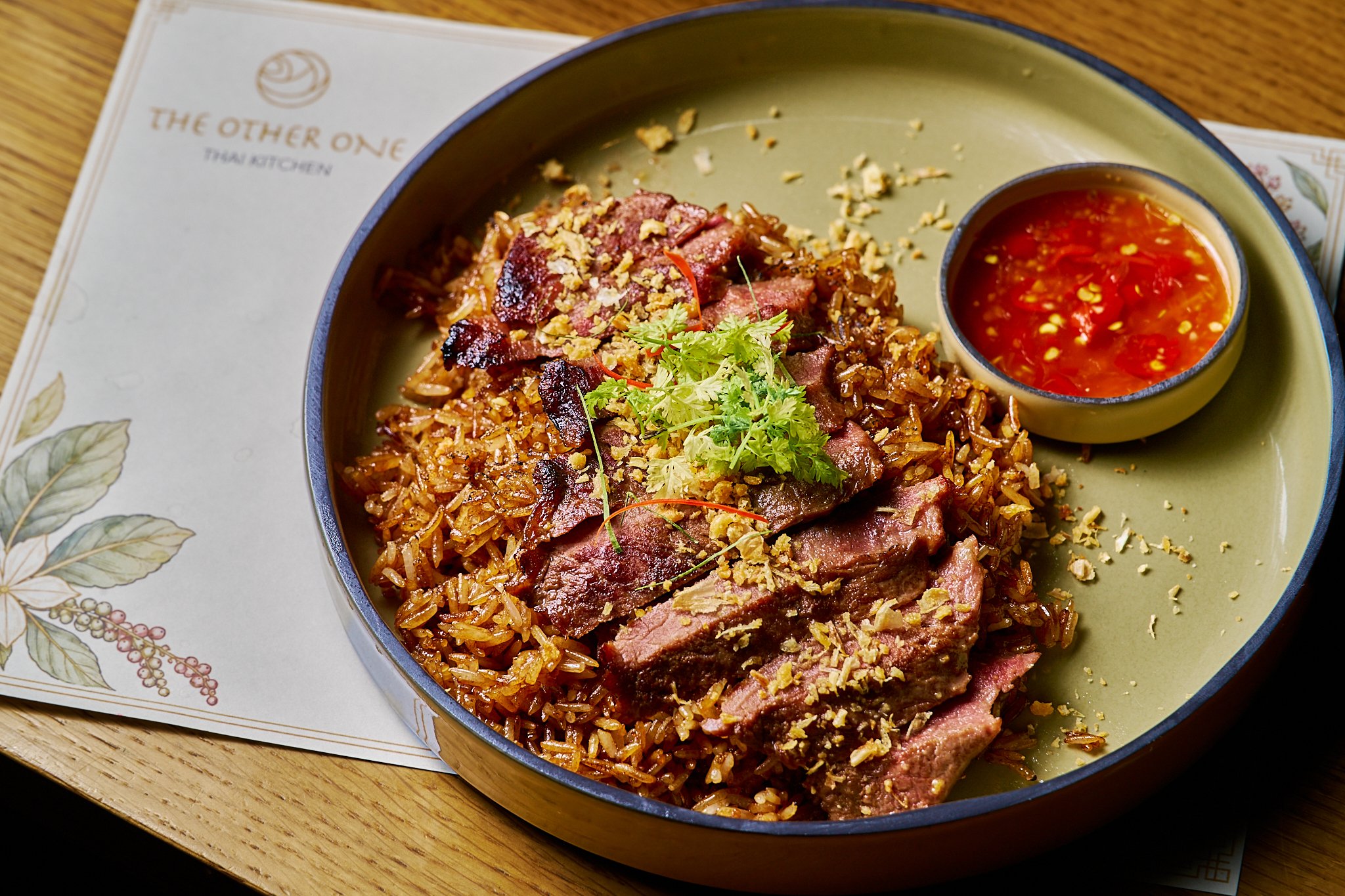 Garlic fried rice topped with grilled beef entrecôte