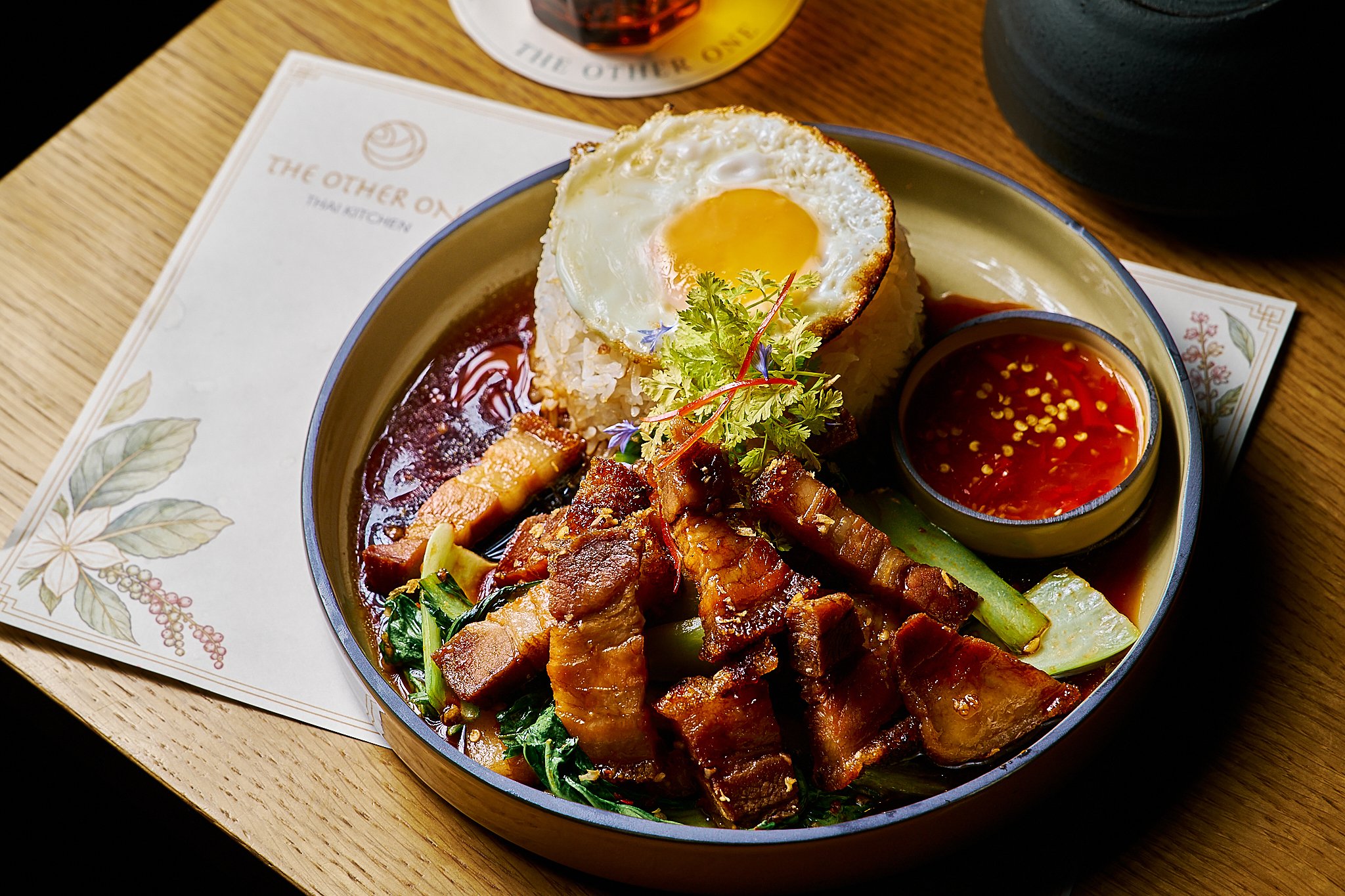 Crispy pork belly with pak choi and fried egg